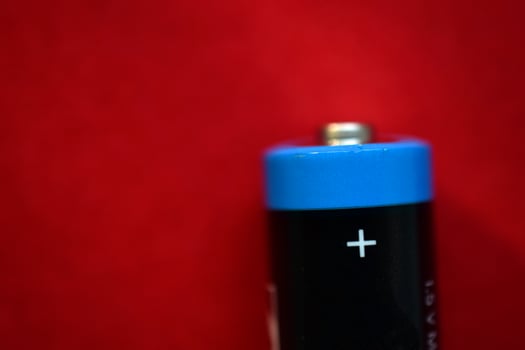 AA finger battery on a red background photo
