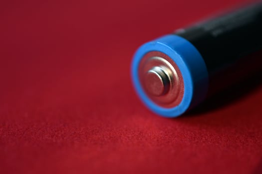 AA finger battery on a red background photo