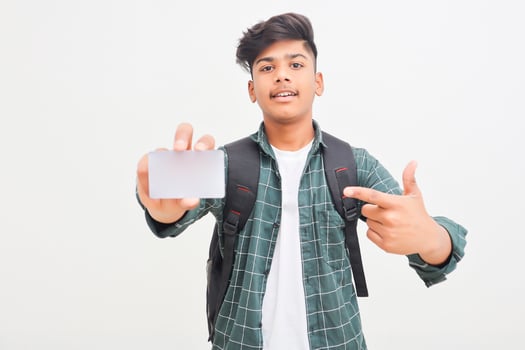 Young indian man showing debit or credit card on white background. photo