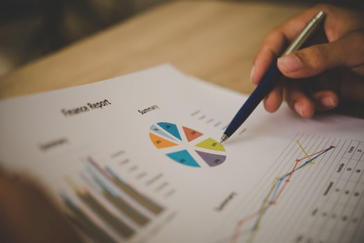 Businessman holding and analyzing investment chart working in office. Business work concept. photo