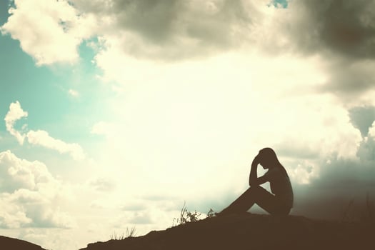 Sad and depressed woman sitting alone photo