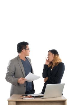 Young business woman standing with her boss conversation about the business at office isolated on white background. photo