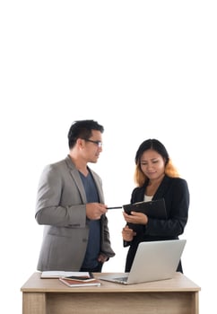 Young business woman standing with her boss conversation about the business at office isolated on white background. photo
