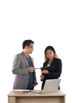 Young business woman standing with her boss conversation about the business at office isolated on white background. photo