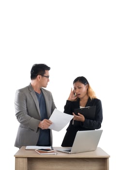 Young business woman standing with her boss conversation about the business at office isolated on white background. photo