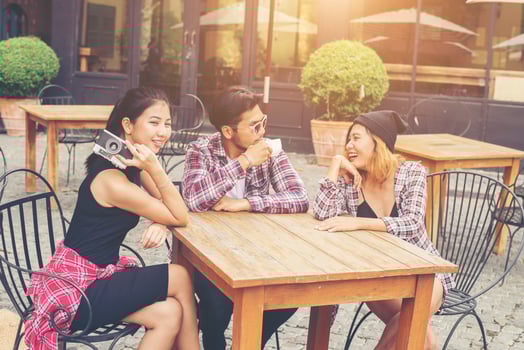 Group of young hipster sitting in a cafe,Young cheerful friends having fun while take time together, Holiday freedom enjoy. photo