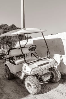 Golf cart buggy cars carts muddy street village Holbox Mexico. photo