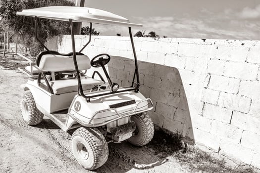 Golf cart buggy cars carts muddy street village Holbox Mexico. photo