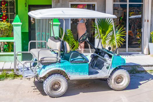 Golf cart buggy cars carts muddy street village Holbox Mexico. photo