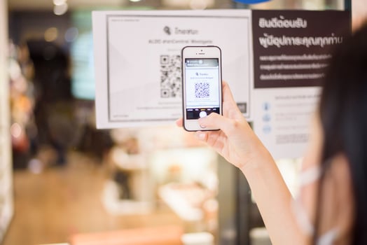 Bangkok, Thailand  - July 17, 2020 of people hand is holding smartphone with Thaichana campaign of Thailand for COVID-19 prevention in shopping center photo