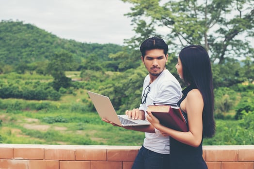 Young education couple talking about education after reading book with laptop ,Relaxing with nature. photo
