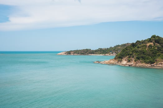 a day of nature island in green sea ocean blue sky white cloud photo