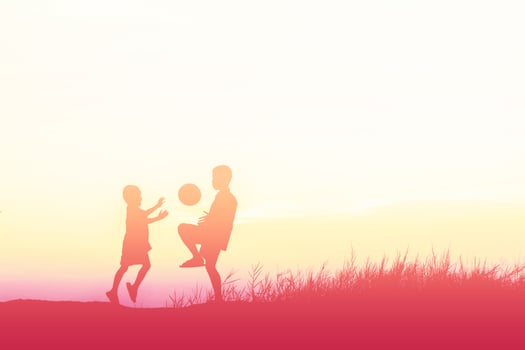 boys playing football at sunset. silhouette concept photo