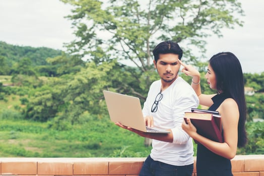 Young education couple talking about education after reading book with laptop ,Relaxing with nature. photo