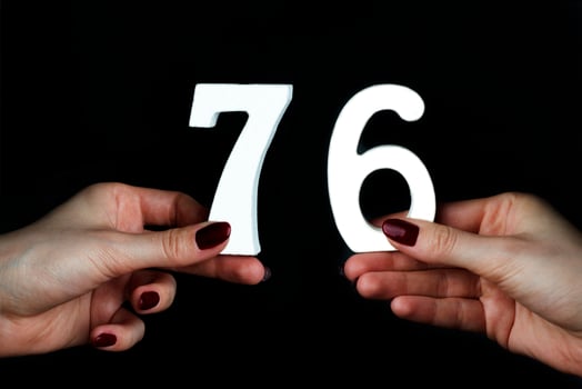 To female hands the figure of seventy-six. photo