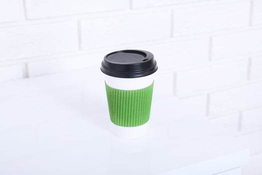 Stylish macro cup of coffee in office. Selective focus and copy space photo