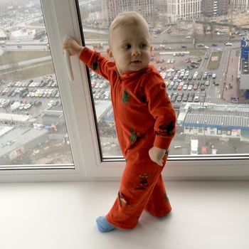 Beautiful baby boy with child face posing photographer near window photo