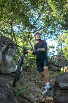 Athletes standing on the mountains with bicycle photo