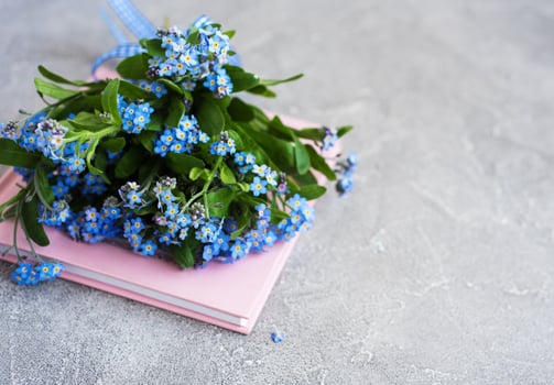 Forget me not flowers and notebook photo
