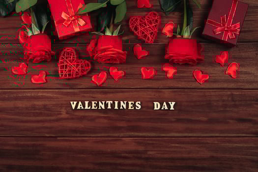 Red roses and hearts on a dark wooden background. photo