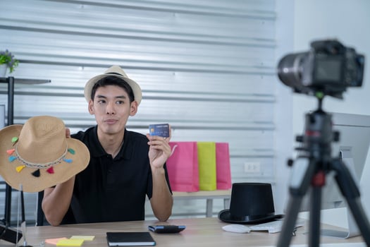 asian man blogger present and review product video broadcast live stream video to a social network. blogging, vlogging, online shopping, and social media concept photo