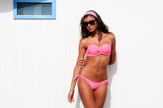 Woman with beautiful body in a beach hut photo
