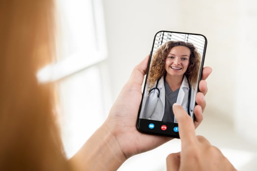 Patient making video call with doctor online via mobile phone, home medical consulation service and telehealth concepts photo
