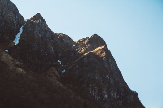 Rock top in sunlight on sky background photo