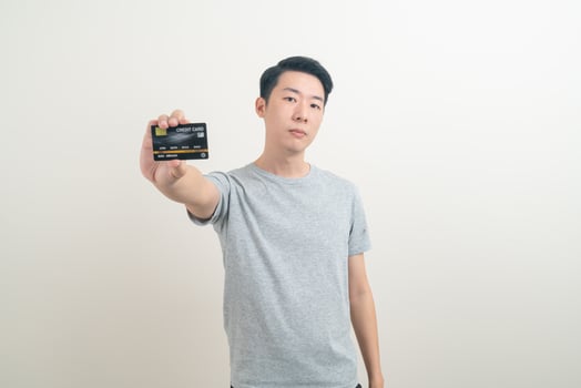 young Asian man holding credit card photo