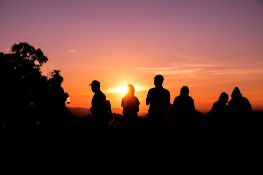 Silhouette tourists stand looking view photo