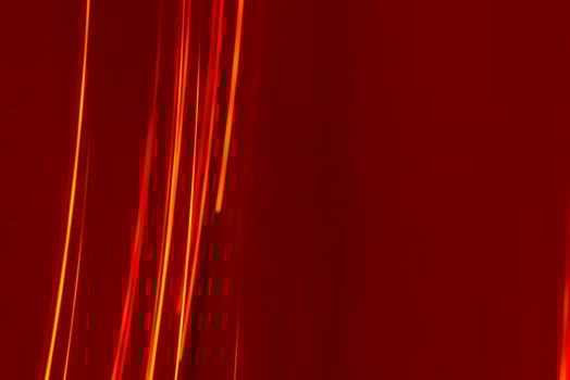Bright red lines rays on a burgundy background. Abstract backdrop with soft blur. photo