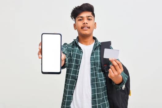 Indian college student showing mobile screen and card on white background. photo
