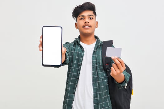 Indian college student showing mobile screen and card on white background. photo