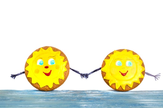 Two homemade gingerbread, cookies in shape of sun. Friendship day celebration concept photo