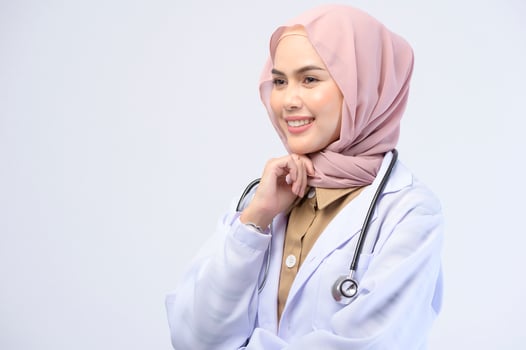 Female muslim doctor with hijab over white background studio. photo