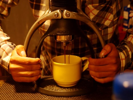Ecfresso coffee from a press machine into a mug Photo