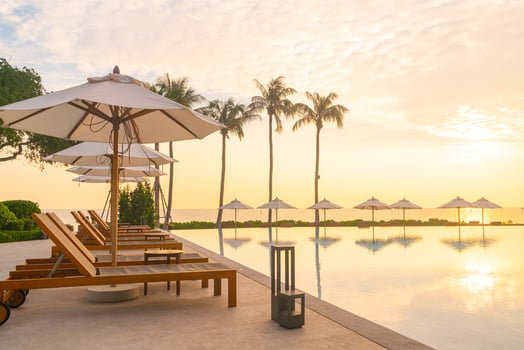 umbrella with bed pool around swimming pool with ocean sea background photo