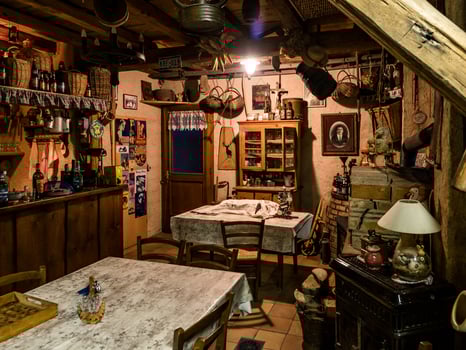 The interior of a tree house. A room decorated with old objects, dried corn and antiques. photo