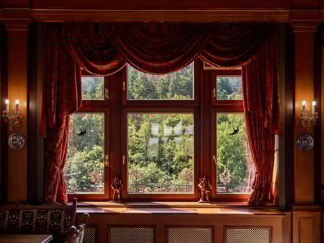 The luxury interior of the living room of the old castle. Sunlight falls from the windows photo