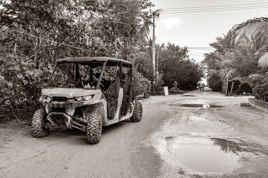 Buggy car golf cart carts muddy street village Holbox Mexico. photo