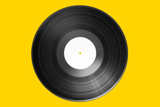 Vinyl record with bank label isolated on yellow background. Mock up photo