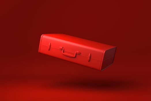 Red Travel Suitcase floating in red background. minimal concept idea creative. monochrome. 3D render. photo