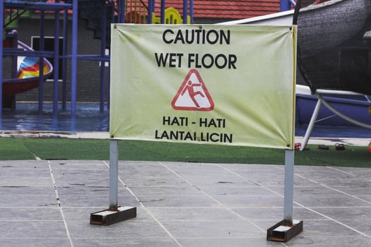wet floor sign on the swimming pool photo