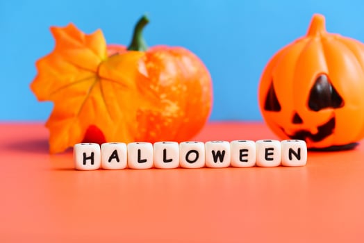 Halloween background with leaves autumn on orange and blue decorated holidays festive concept - funny faces jack o lantern pumpkin halloween decorations for party accessories object photo