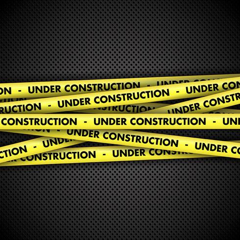 Under construction on tape on metal background vector