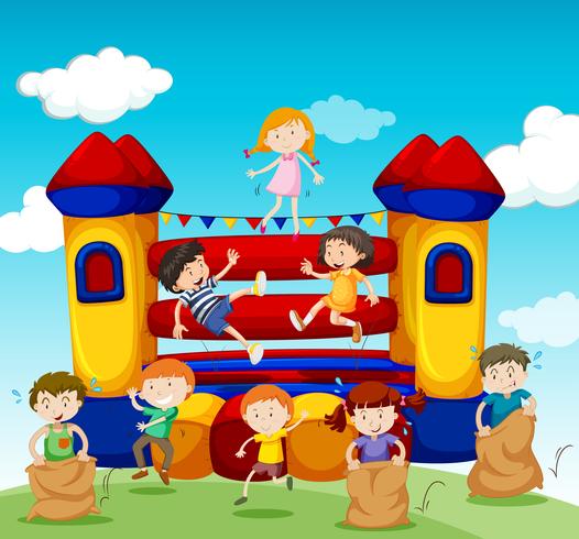 Children playing at the bouncing house vector
