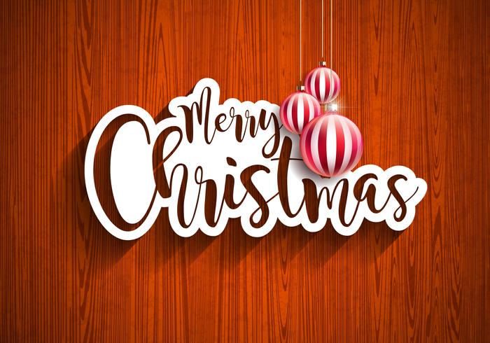 Ejemplo de las letras de la mano de la Feliz Navidad con la etiqueta de papel y las bolas de cristal ornamentales rojas en fondo de madera del vintage. Vector EPS 10 Holiday Design.