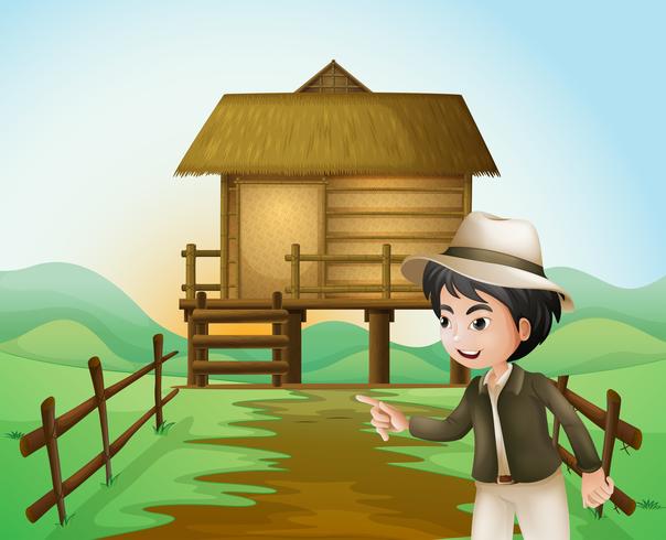 A boy with a hat standing near the nipa hut vector