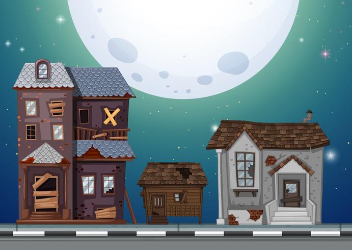 Three old houses on the street at night vector