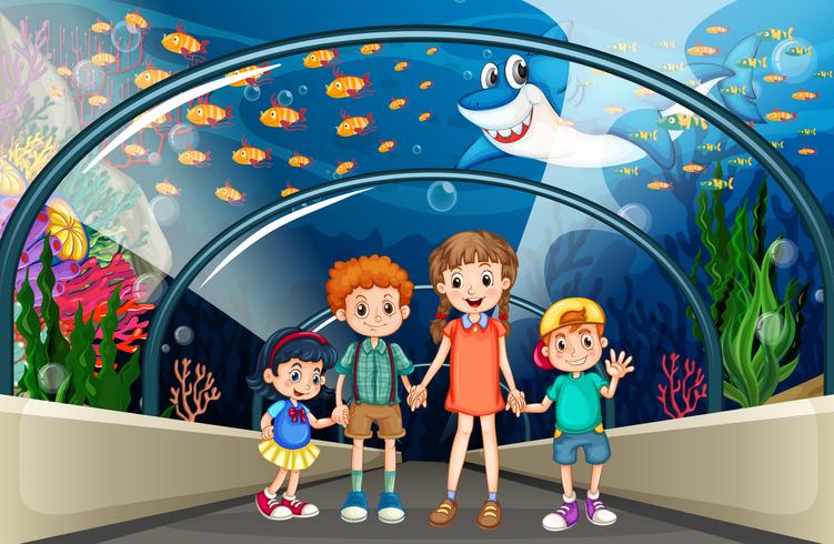 Children visiting aquarium full of fish vector
